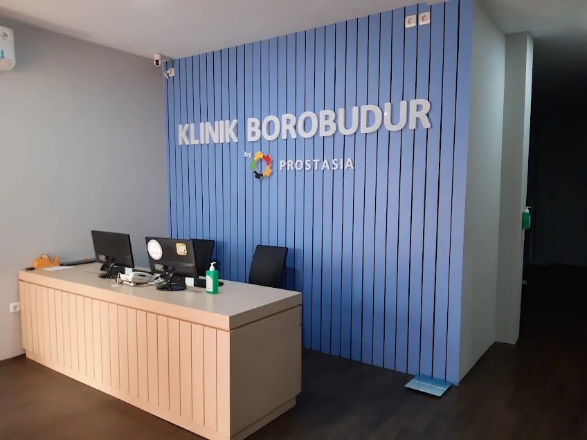 Ruang resepsionis Klinik Borobudur dengan logo dinding biru